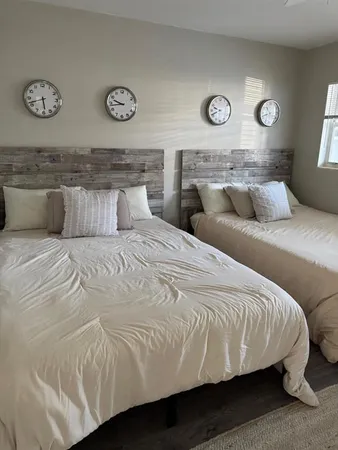 a bedroom with a bed and a wall clock