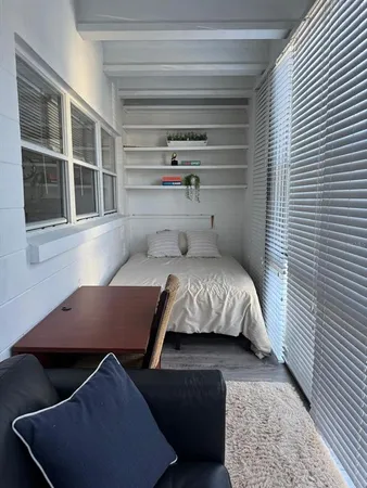 a bedroom with a bed and window