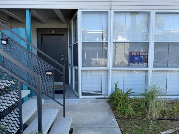 a view of front door and potted plants