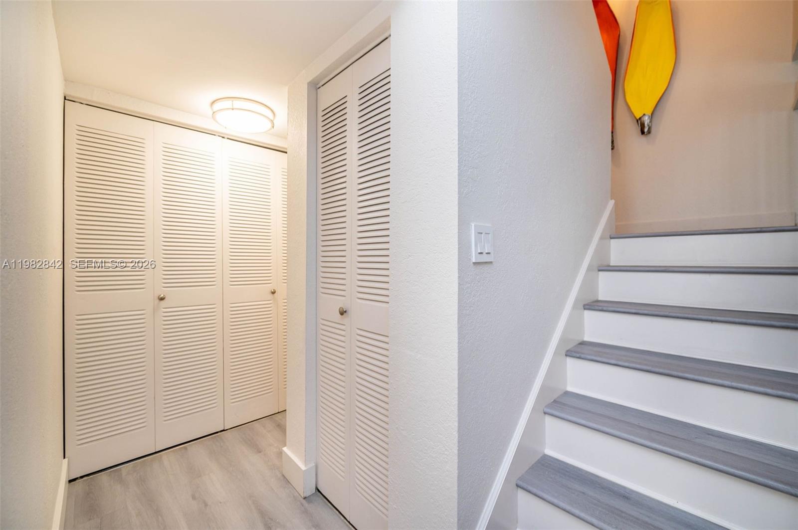 4702 Southwest 67th Avenue, Unit O7 Miami, FL 33155 - Photo 11 of 32 a view of a hallway with wooden floor and entryway