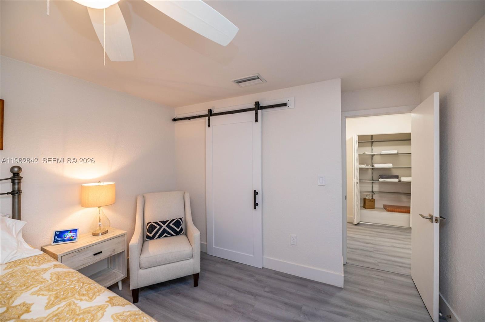 4702 Southwest 67th Avenue, Unit O7 Miami, FL 33155 - Photo 14 of 32 a bedroom with a bed and wooden floor