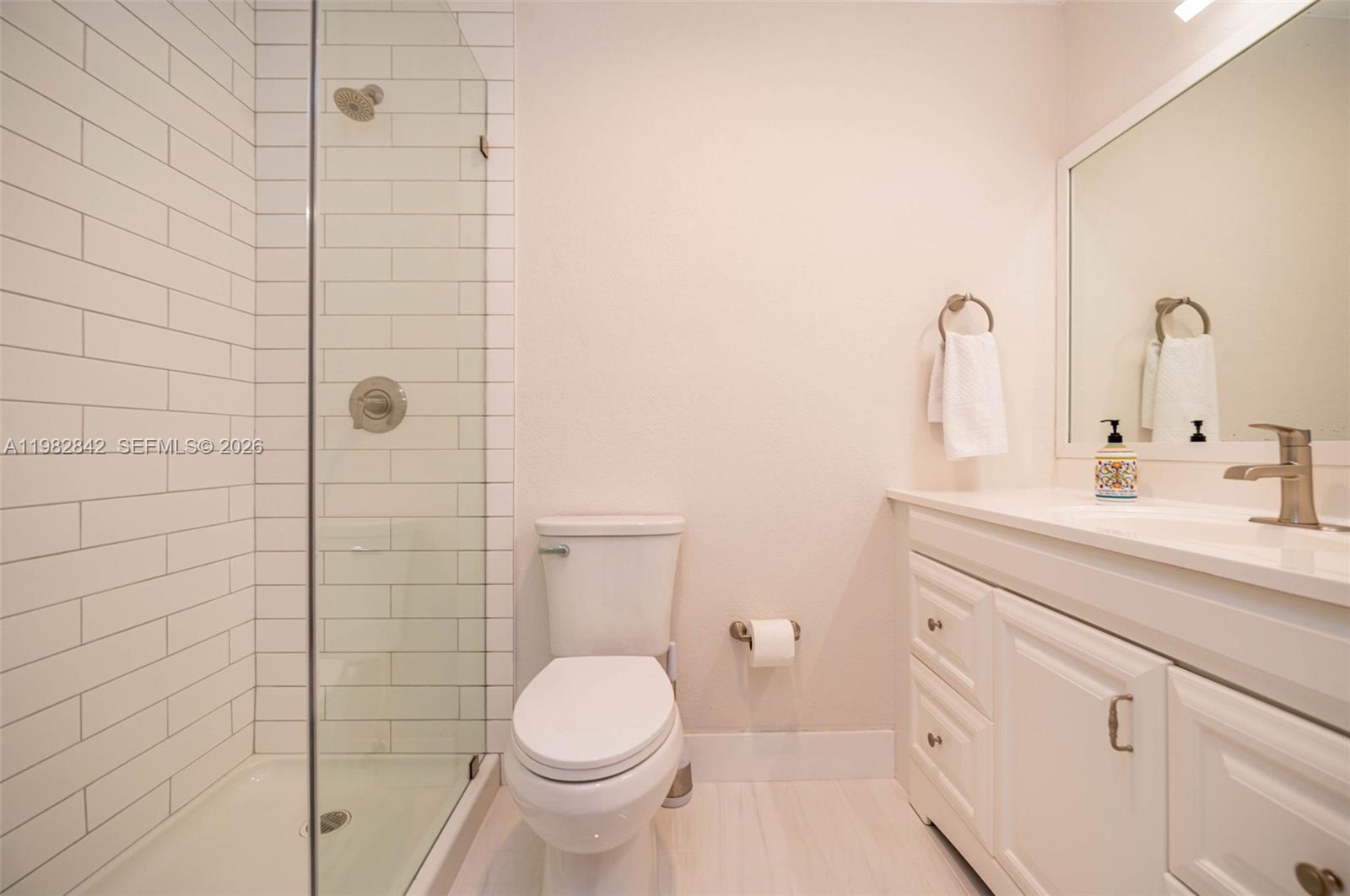 4702 Southwest 67th Avenue, Unit O7 Miami, FL 33155 - Photo 16 of 32 a bathroom with a sink a toilet and shower