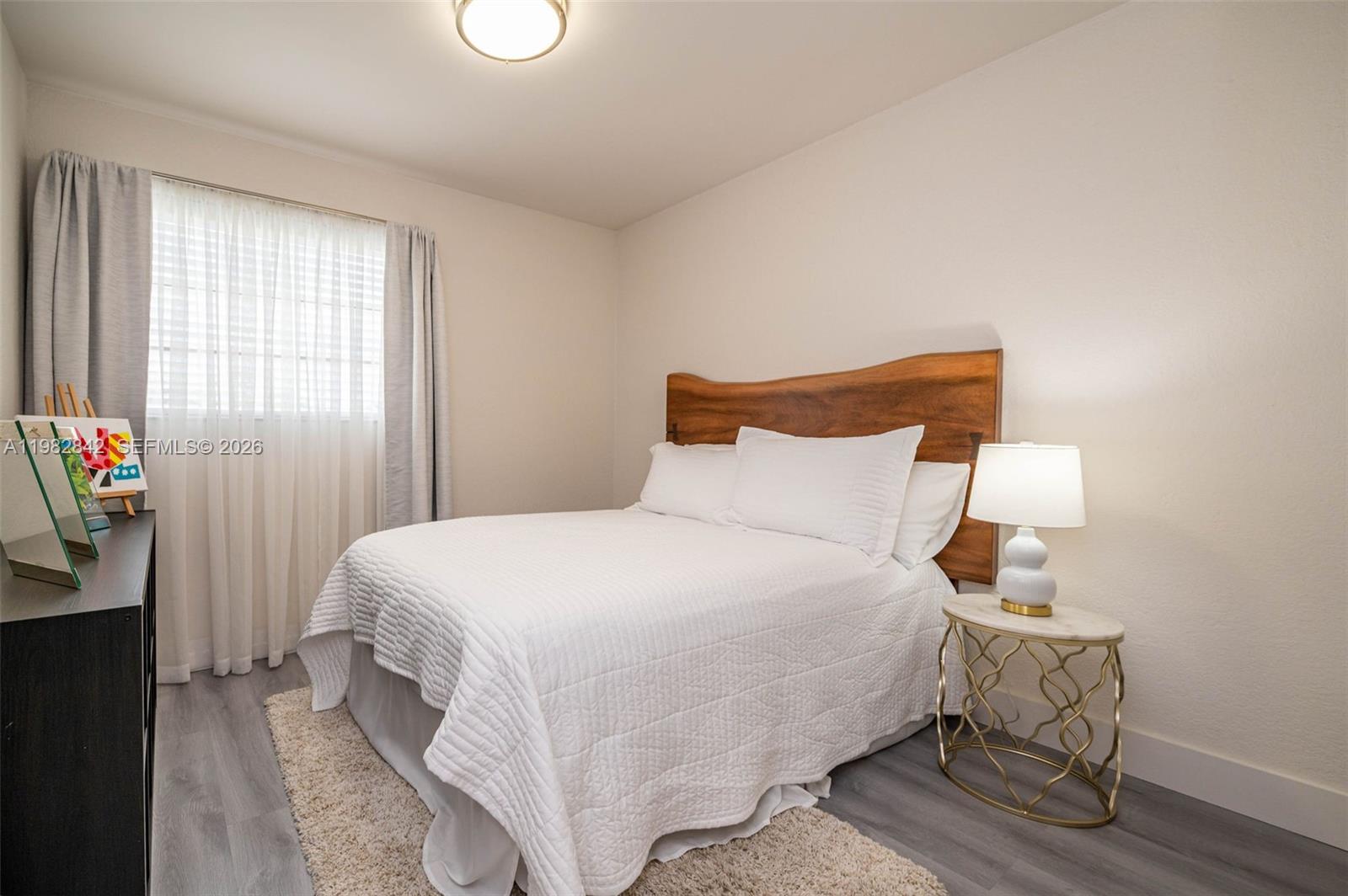 4702 Southwest 67th Avenue, Unit O7 Miami, FL 33155 - Photo 18 of 32 a bedroom with a bed and a window