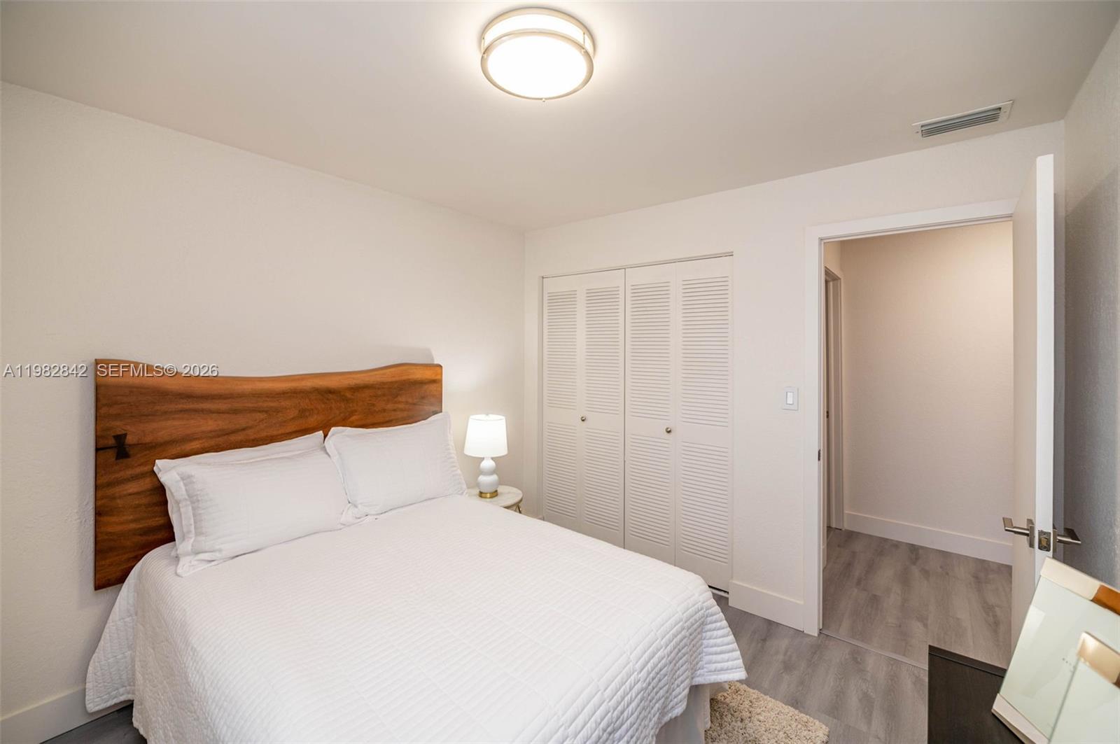 4702 Southwest 67th Avenue, Unit O7 Miami, FL 33155 - Photo 19 of 32 a bedroom with a bed and chandelier