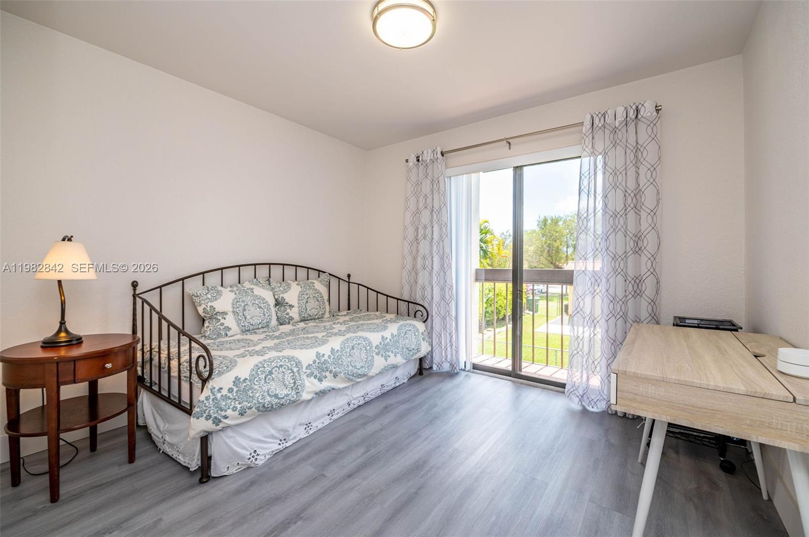 4702 Southwest 67th Avenue, Unit O7 Miami, FL 33155 - Photo 20 of 32 a view of a bedroom with furniture and wooden floor