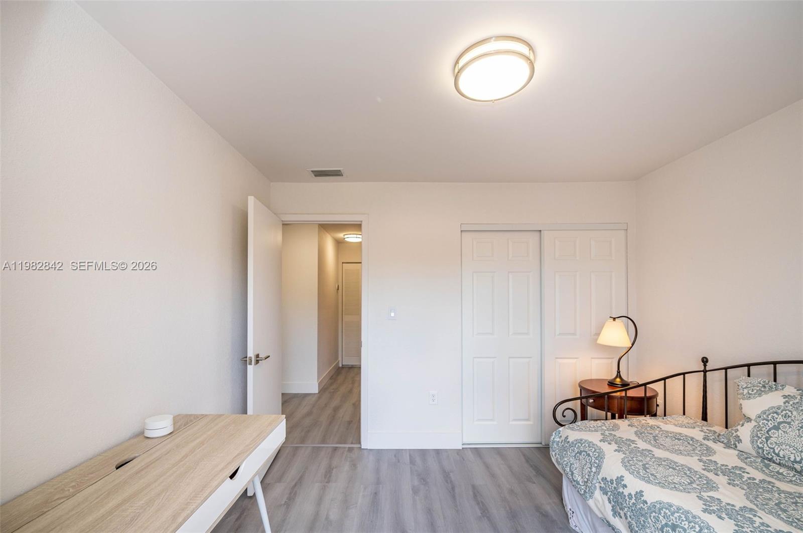 4702 Southwest 67th Avenue, Unit O7 Miami, FL 33155 - Photo 21 of 32 a bedroom with a bed and a mirror