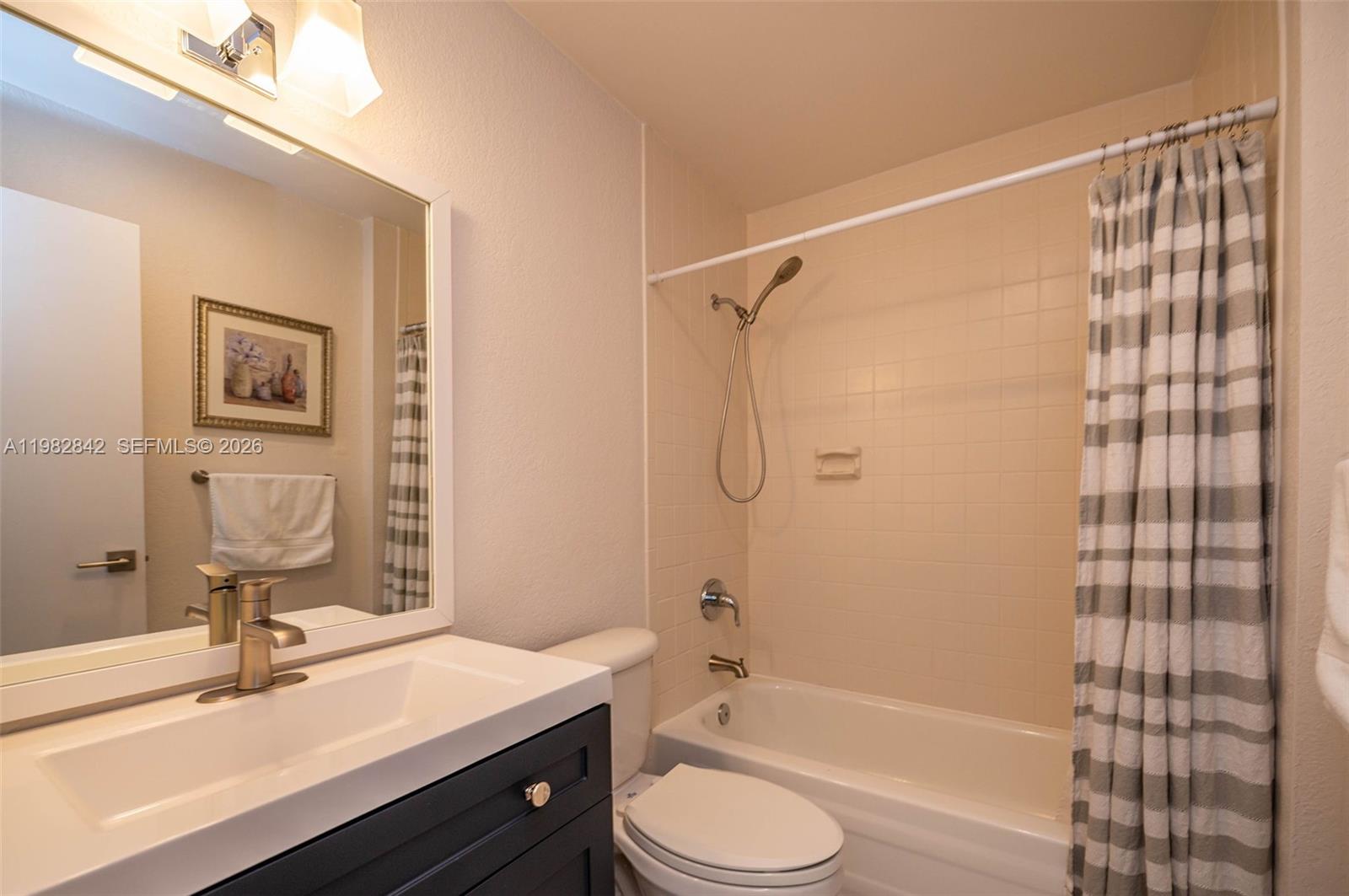 4702 Southwest 67th Avenue, Unit O7 Miami, FL 33155 - Photo 23 of 32 a bathroom with a sink toilet tub and shower
