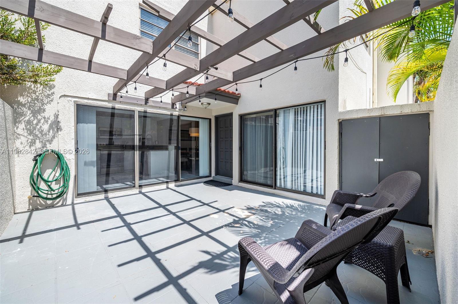 4702 Southwest 67th Avenue, Unit O7 Miami, FL 33155 - Photo 28 of 32 a view of a chairs and table in a room