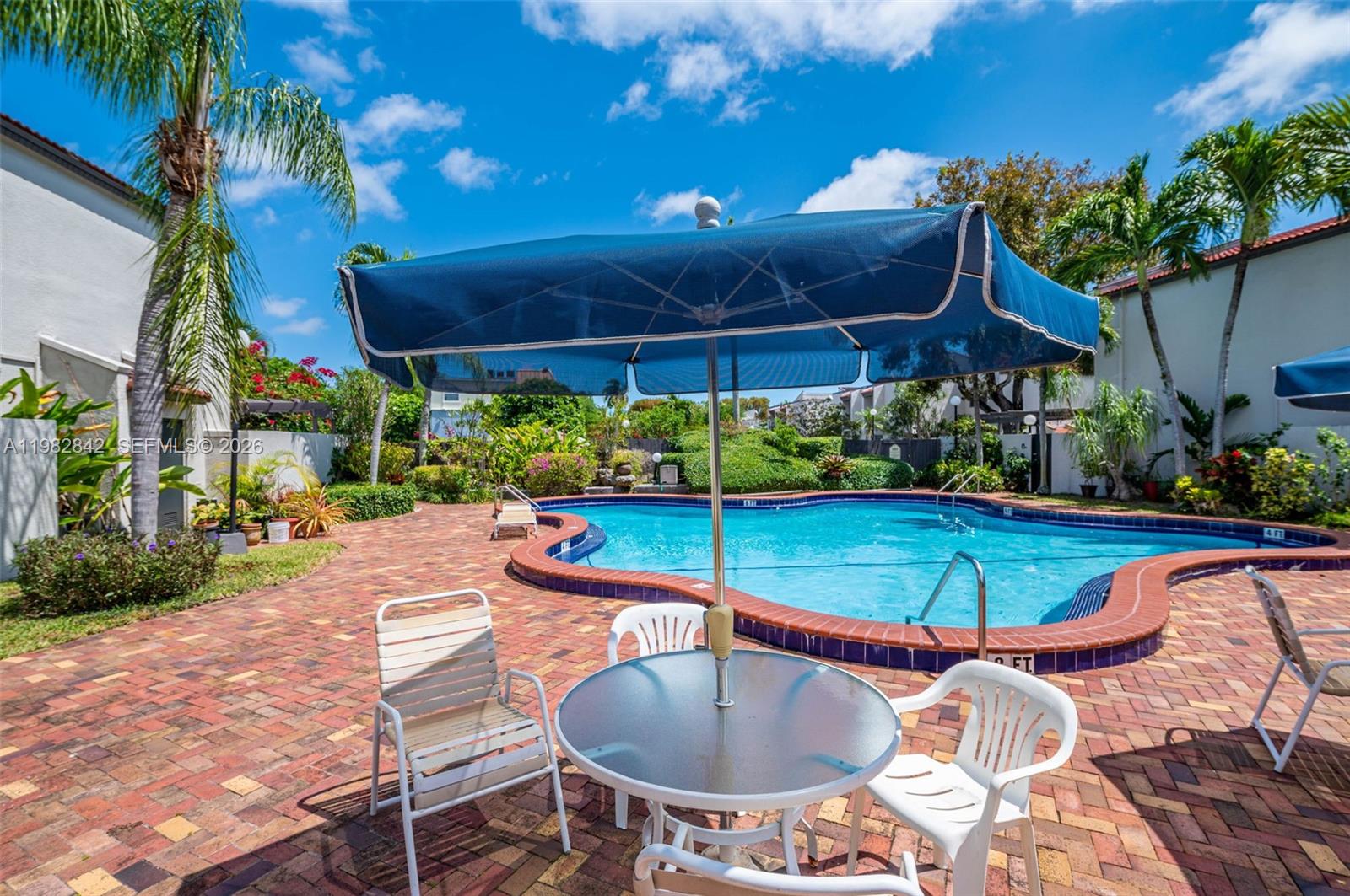 4702 Southwest 67th Avenue, Unit O7 Miami, FL 33155 - Photo 30 of 32 a view of a backyard with swimming pool and furniture