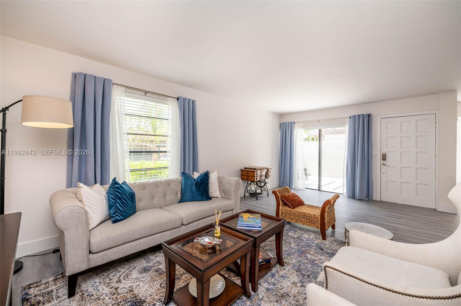 4702 Southwest 67th Avenue, Unit O7 Miami, FL 33155 - Photo 3 of 32 a living room with furniture and a window