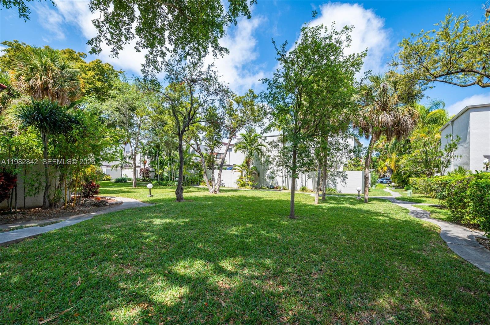 4702 Southwest 67th Avenue, Unit O7 Miami, FL 33155 - Photo 32 of 32 a view of a trees with a big yard