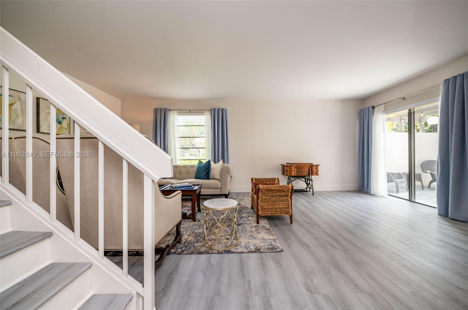 4702 Southwest 67th Avenue, Unit O7 Miami, FL 33155 - Photo 4 of 32 a living room with furniture and a wooden floor