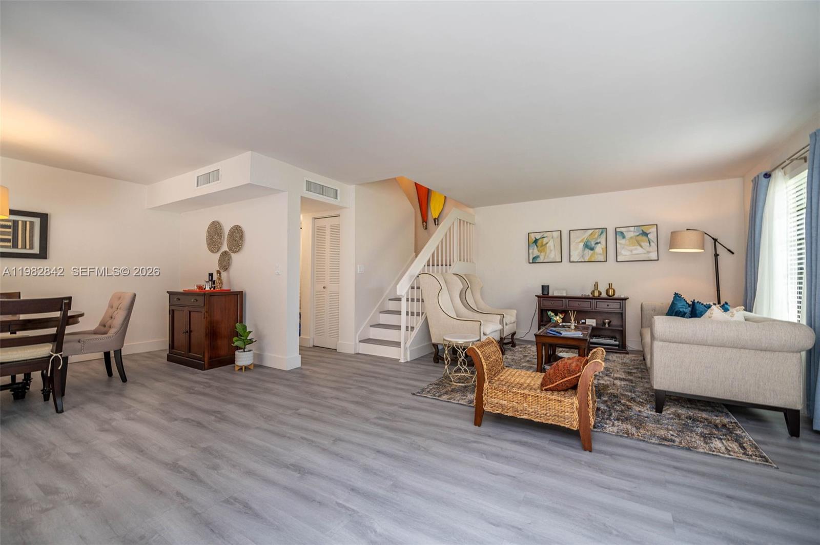 4702 Southwest 67th Avenue, Unit O7 Miami, FL 33155 - Photo 5 of 32 a living room with furniture and a wooden floor