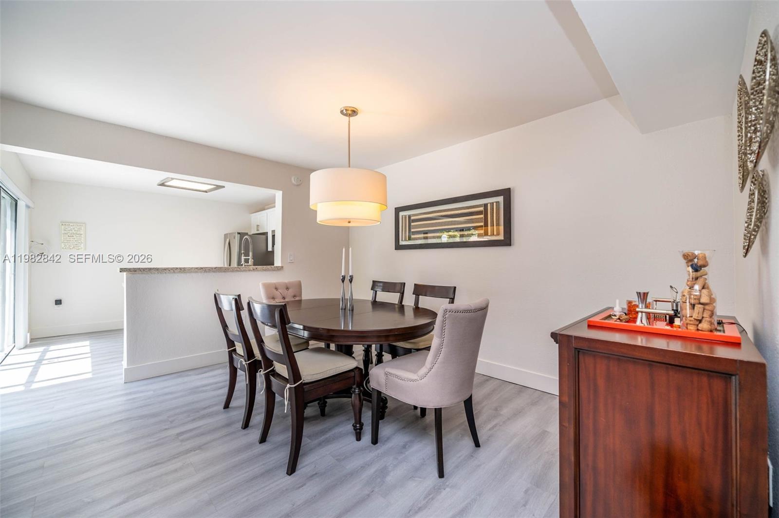 4702 Southwest 67th Avenue, Unit O7 Miami, FL 33155 - Photo 6 of 32 a view of a dining room with furniture and wooden floor