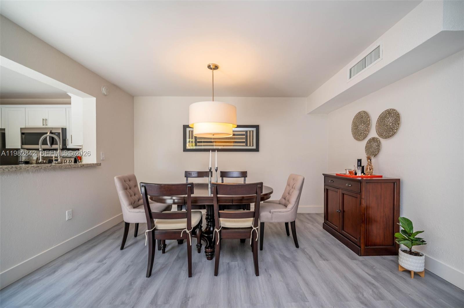 4702 Southwest 67th Avenue, Unit O7 Miami, FL 33155 - Photo 7 of 32 a view of a dining room with furniture and wooden floor