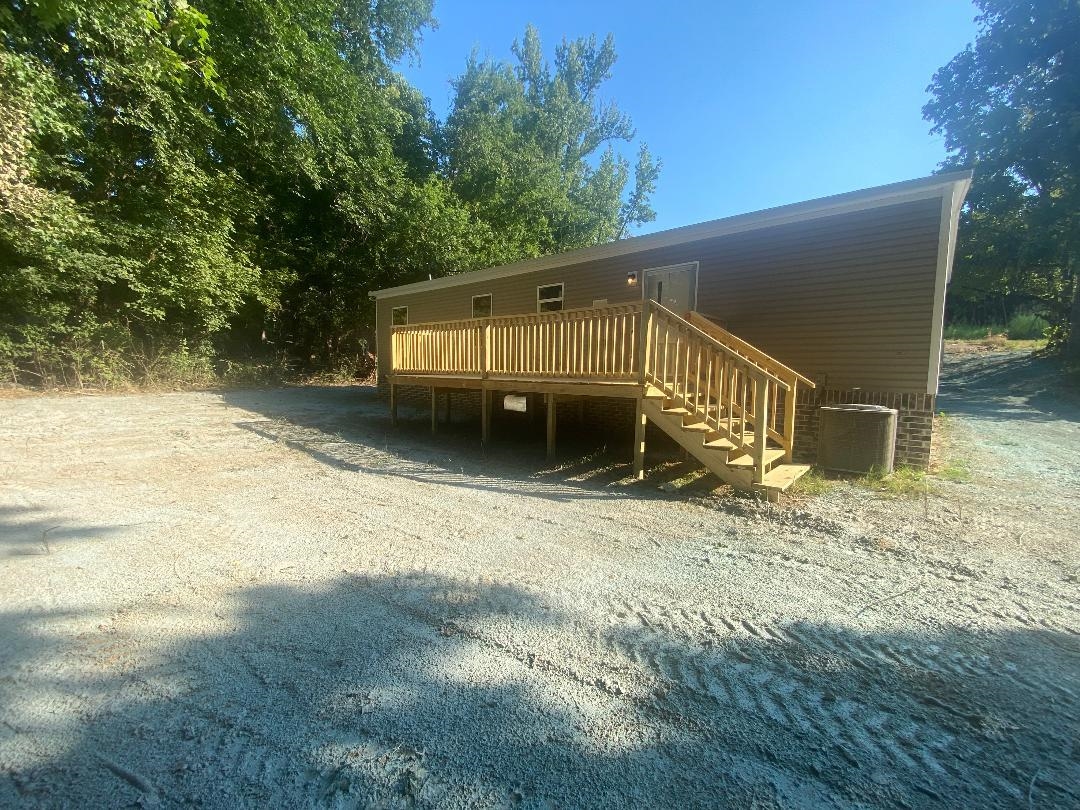 106 Simmons Road Munford, TN 38058 - Photo 25 of 30 Exterior featuring horizontal siding, a newly constructed wood deck with railings and stairs.