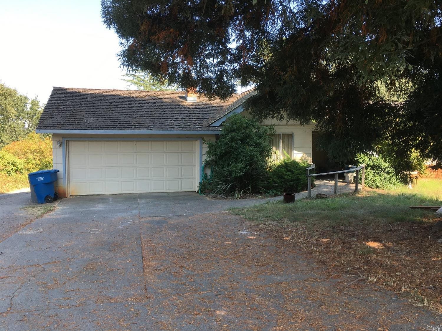 a view of a house with a yard and garage