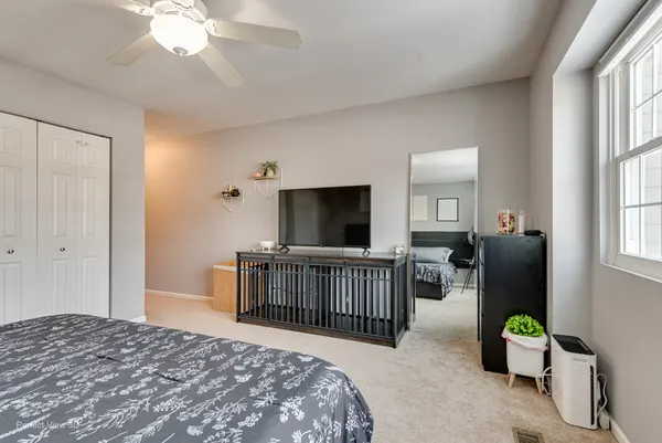 a bedroom with a bed and flat screen tv