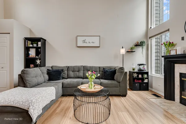 a living room with furniture a fireplace and a flat screen tv