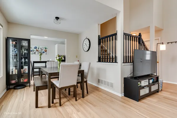 a view of a dining room with furniture and wooden floor