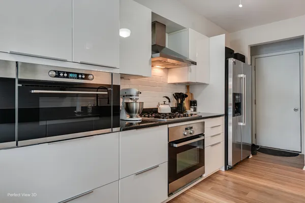 a kitchen with stainless steel appliances a stove a microwave and cabinets