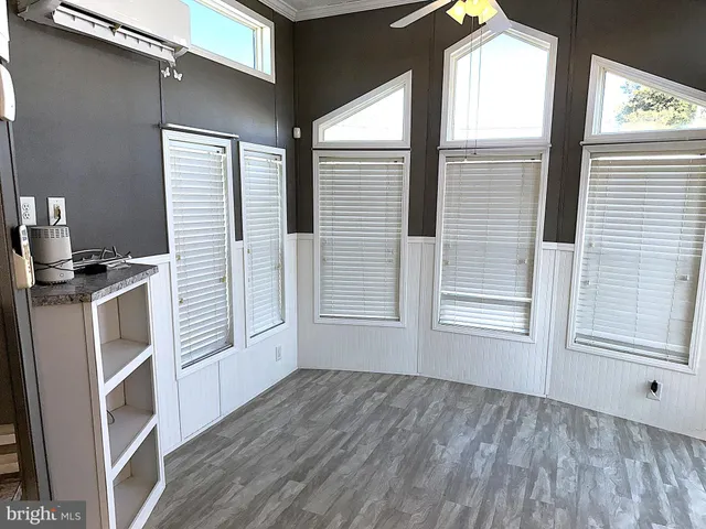 a view of a kitchen with wooden floor and a window
