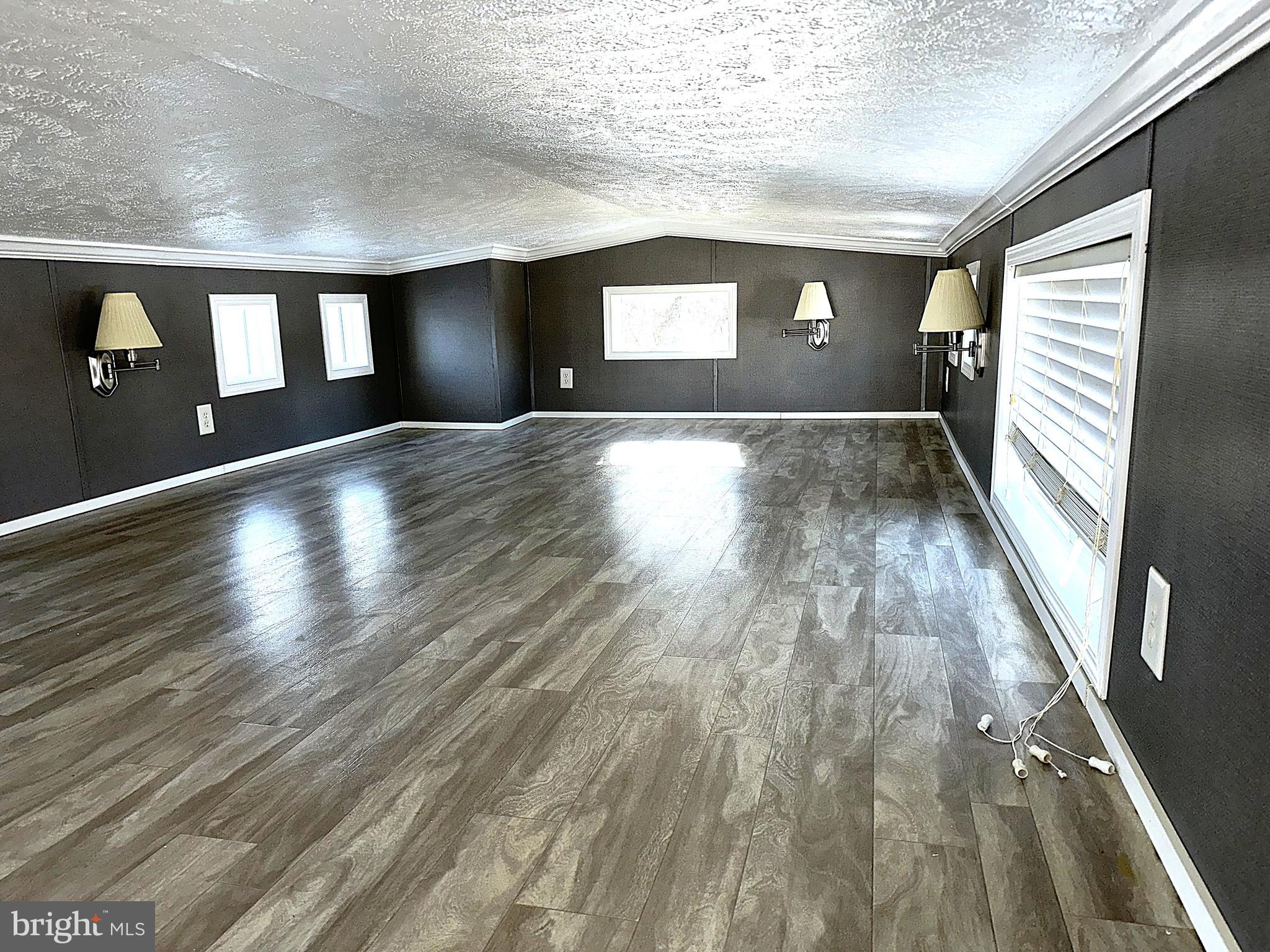 56 3rd Street Lothian, MD 20711 - Photo 13 of 25 a view of empty room with wooden floor and fan