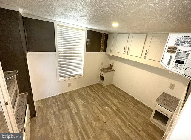 a bedroom with a bed and a flat tv screen on dresser