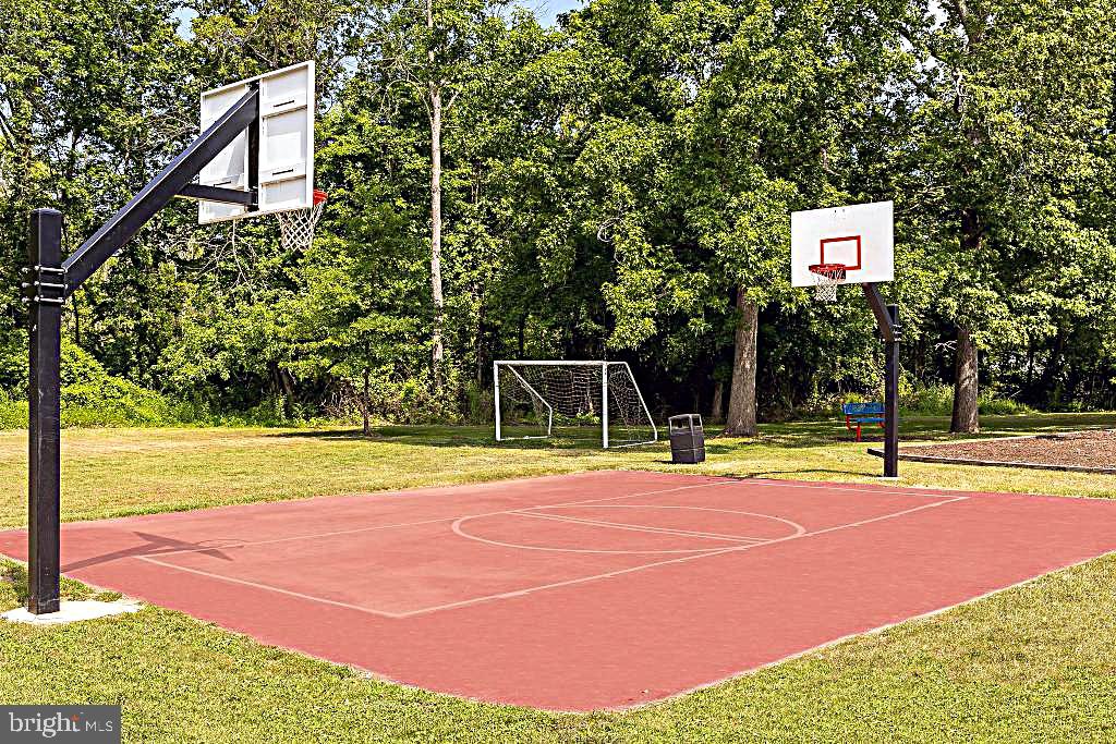 56 3rd Street Lothian, MD 20711 - Photo 21 of 25 a basketball court with view of trees in the background