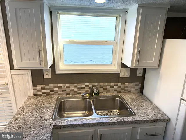a kitchen with sink and window