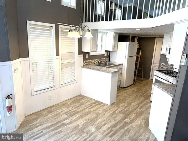 a kitchen with a refrigerator and a stove