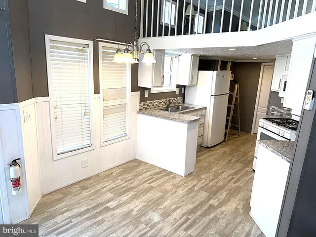 a kitchen with a refrigerator and a stove