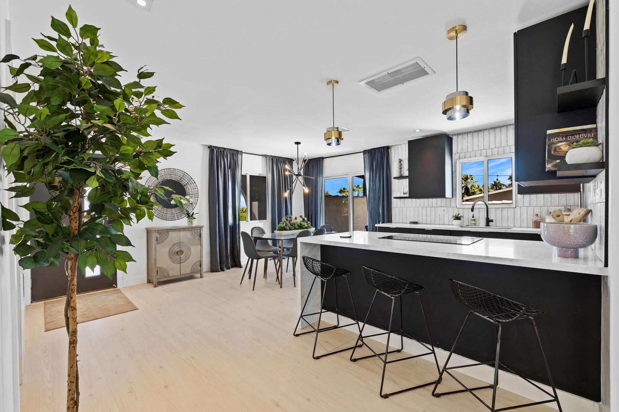 68175 Terrace Road Cathedral City, CA 92234 - Photo 30 of 53 a kitchen with a sink a table and chairs in it