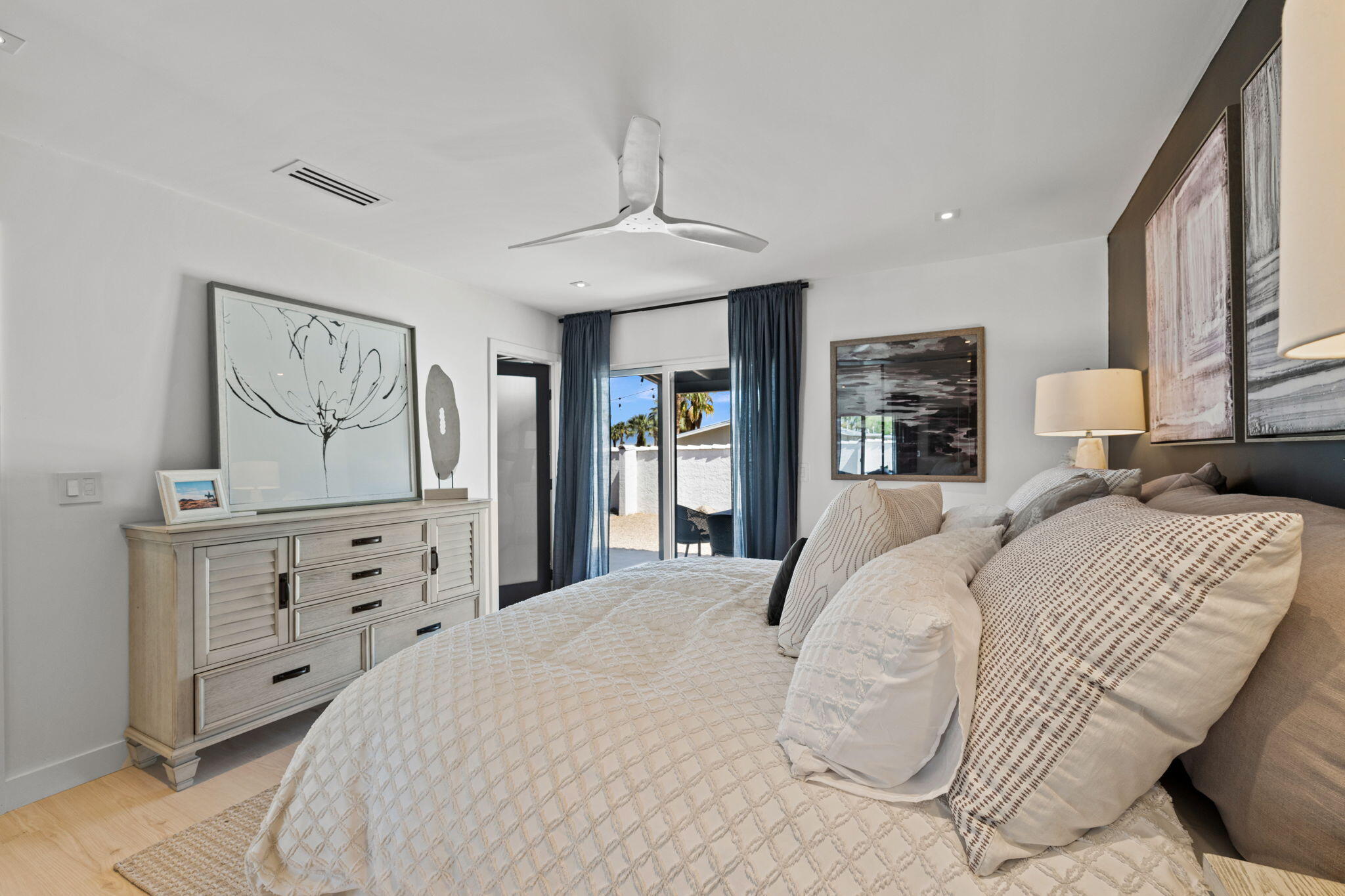 68175 Terrace Road Cathedral City, CA 92234 - Photo 44 of 53 a bedroom with a large bed and a chandelier