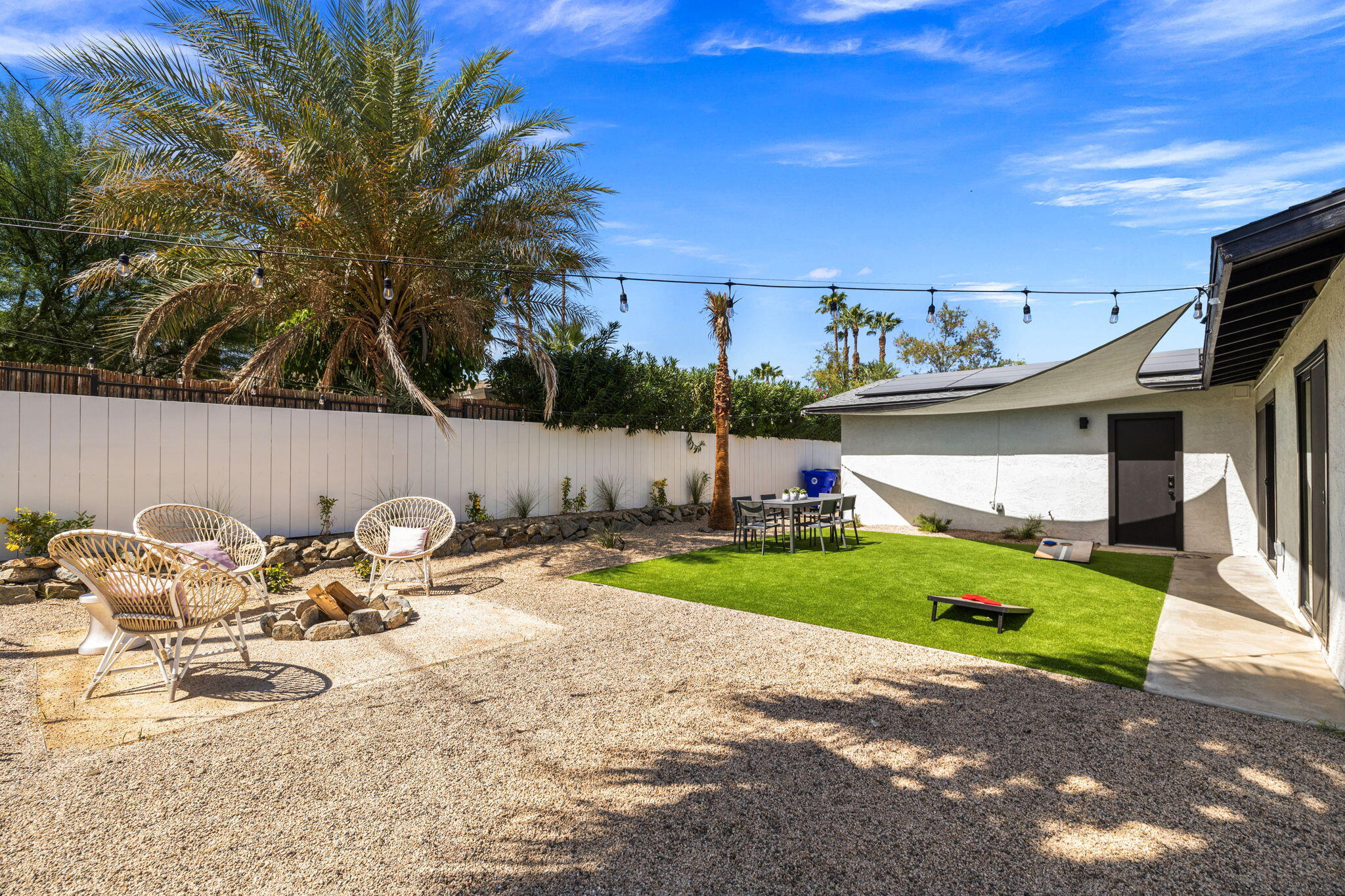 68175 Terrace Road Cathedral City, CA 92234 - Photo 8 of 53 a view of a backyard with table and chairs potted plants and large tree