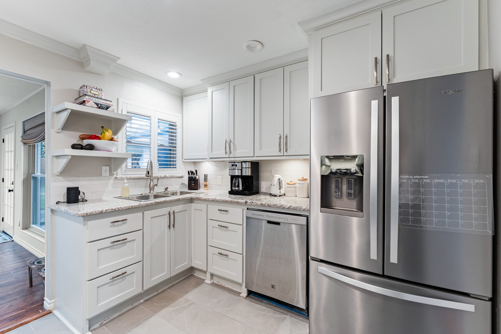4610 Lido Lane Houston, TX 77092 - Photo 18 of 19 a kitchen with white cabinets stainless steel appliances and a window