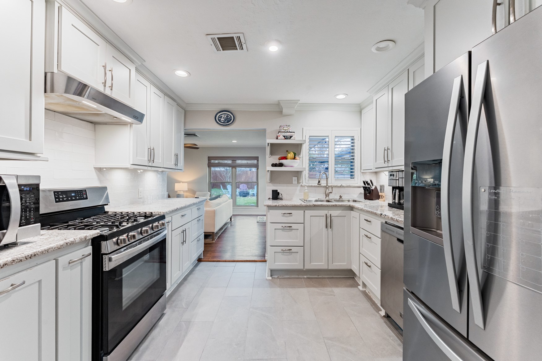4610 Lido Lane Houston, TX 77092 - Photo 6 of 19 a kitchen with stainless steel appliances granite countertop a stove a sink dishwasher a refrigerator and cabinets with wooden floor