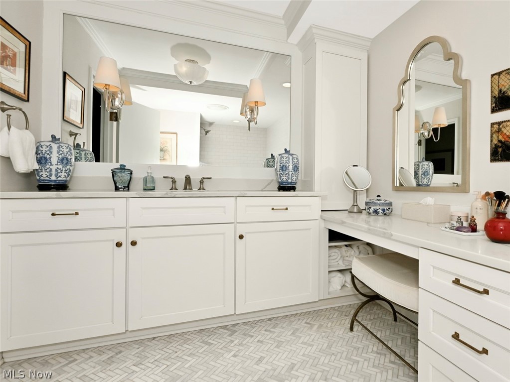 275 North Portage Path, Unit 3B Akron, OH 44303 - Photo 10 of 16 The vanity area features white cabinetry with bronze hardware, a large mirror, and a makeup vanity with an arched mirror