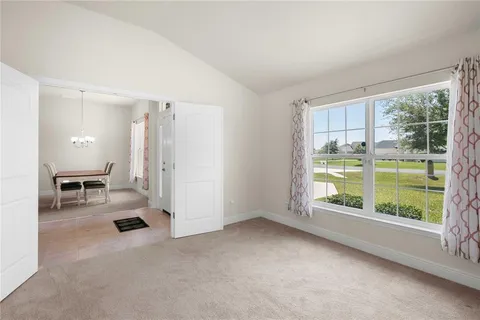 a view of a dining room with furniture and chandelier