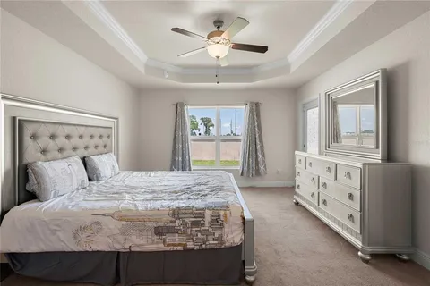 a en suite bathroom with a granite countertop sink a mirror and a vanity