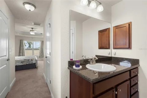 a kitchen with kitchen island granite countertop a sink a counter top space appliances and cabinets