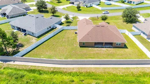 an aerial view of a pool patio yard and outdoor seating