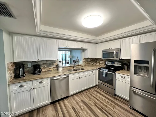 a kitchen with a refrigerator sink and stove