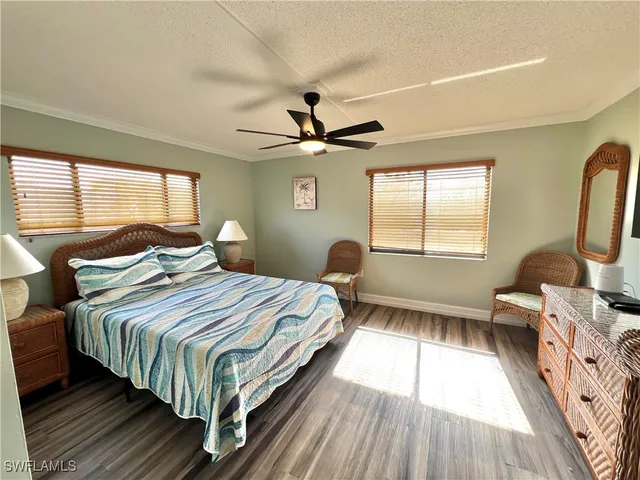 a bedroom with a bed a couch and dresser