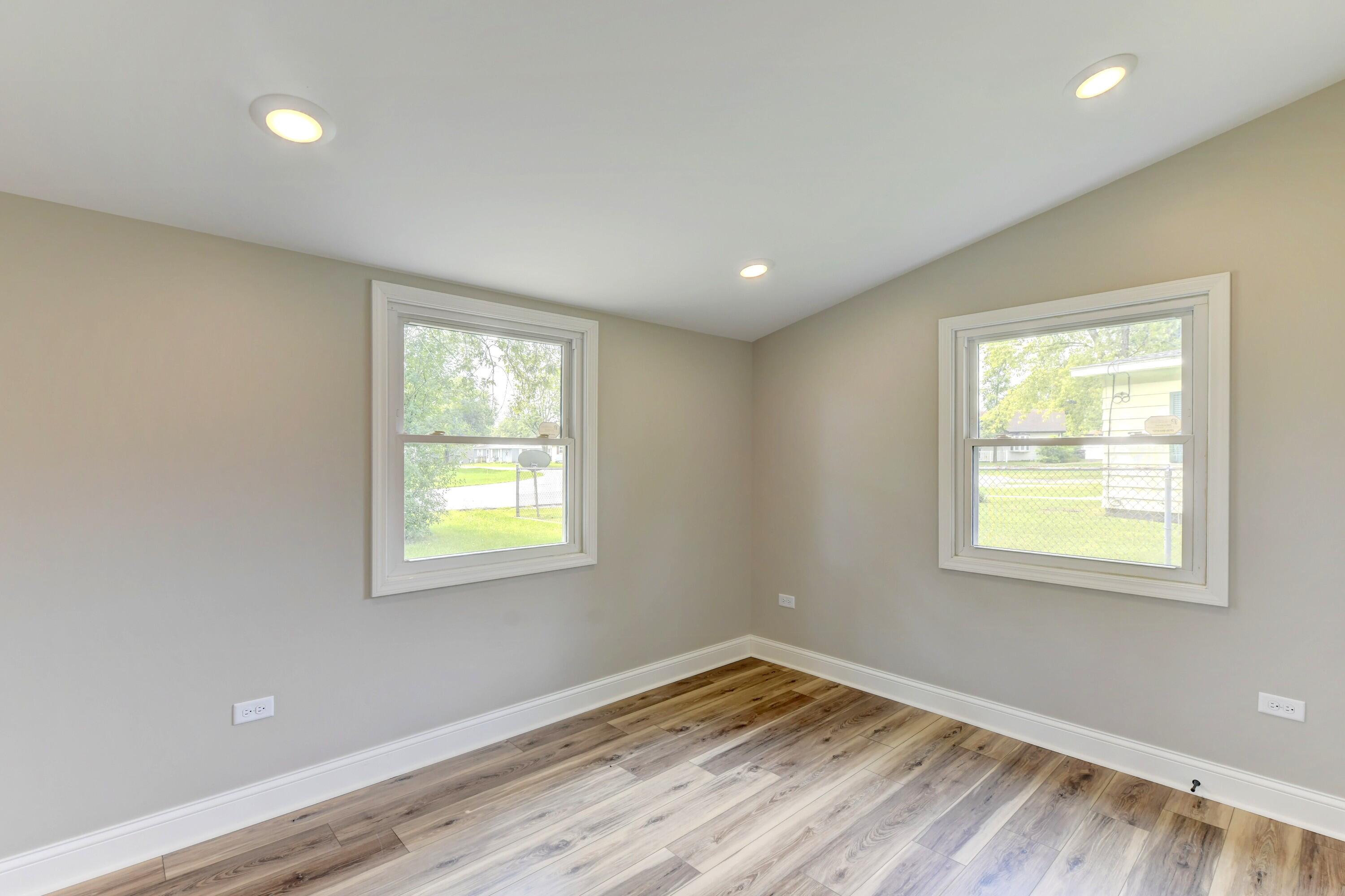 3908 West 127th Place Crown Point, IN 46307 - Photo 11 of 18 a view of an empty room with wooden floor and a window