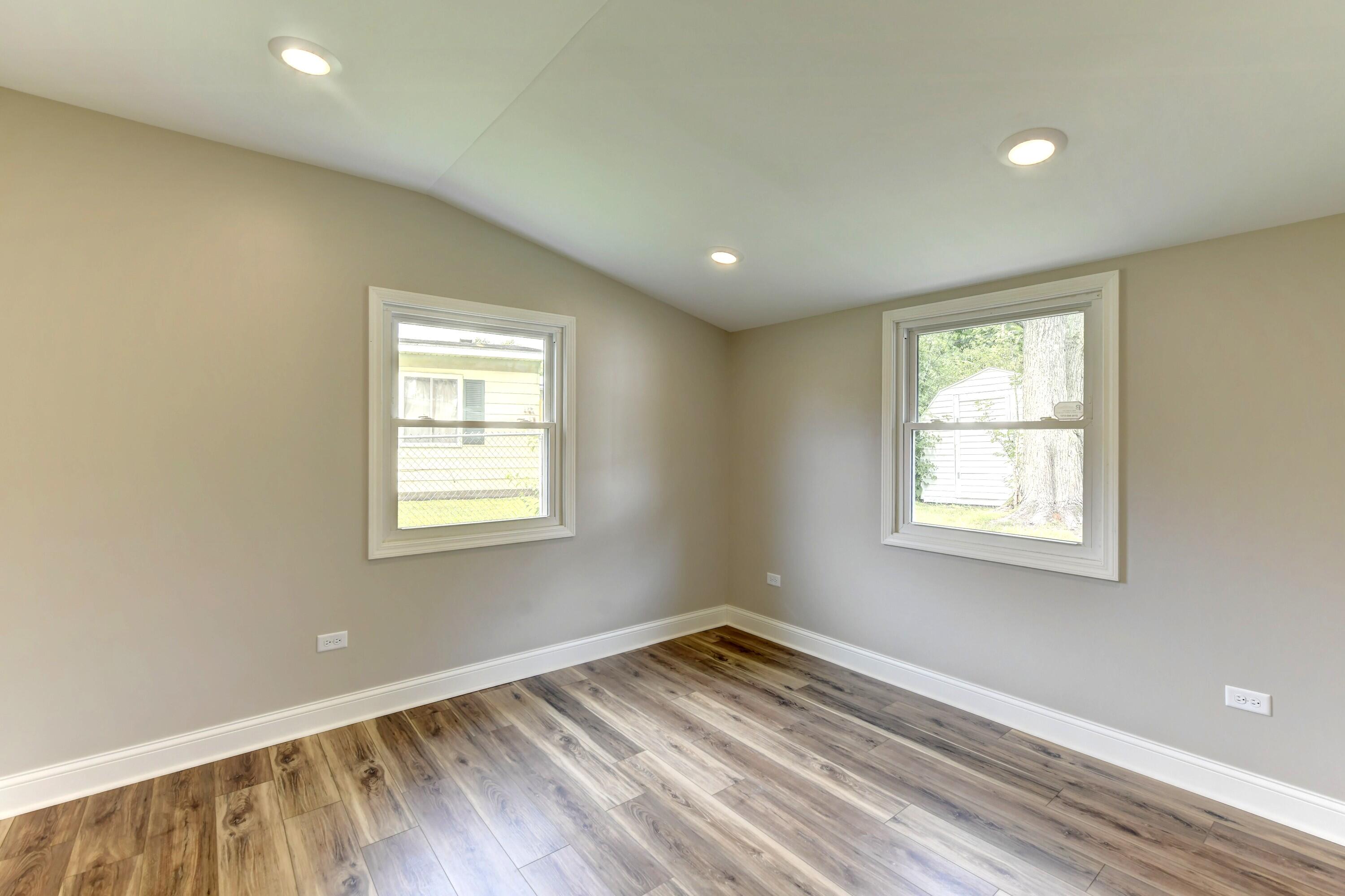 3908 West 127th Place Crown Point, IN 46307 - Photo 13 of 18 a view of empty room with wooden floor and fan