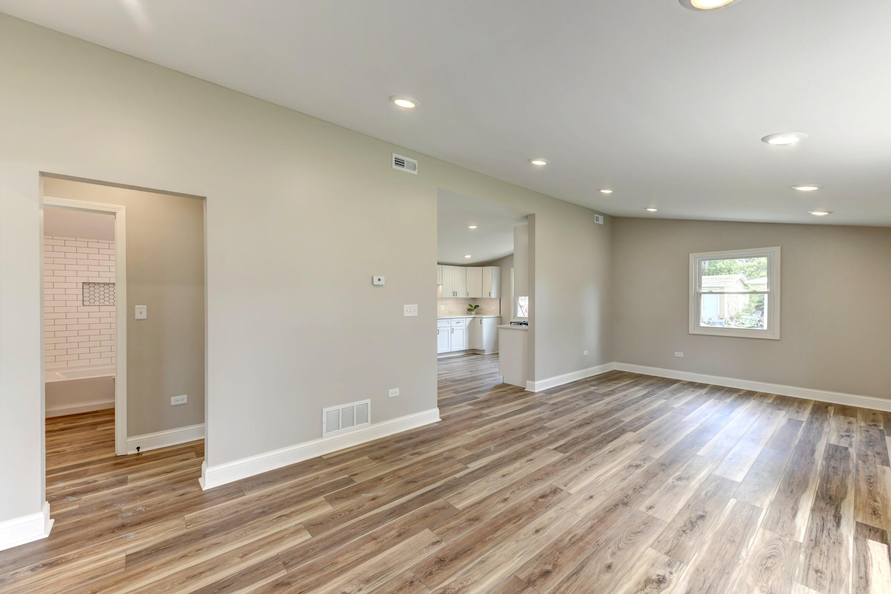 3908 West 127th Place Crown Point, IN 46307 - Photo 7 of 18 an empty room with wooden floor and windows