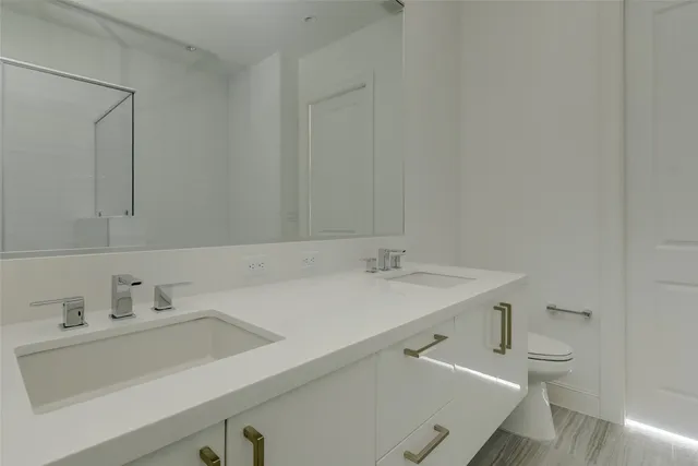 a view of a room with wooden floor and a window