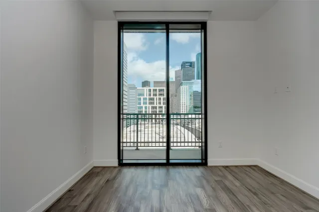 a view of a room with wooden floor and windows