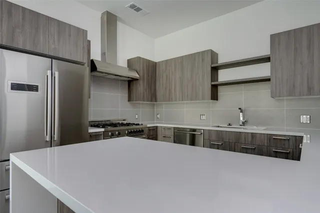 a kitchen with wooden cabinets and a stove top oven